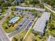 Aerial view of the condo community with lush landscaping and a community pool at 112 W Cypress Ct, Oldsmar, FL 34677