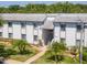 Inviting condo exterior with lush landscaping and a well-maintained facade with stairs to the second floor at 112 W Cypress Ct, Oldsmar, FL 34677