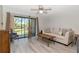 Comfortable living room with a ceiling fan and sliding glass doors with a view of the outdoors at 112 W Cypress Ct, Oldsmar, FL 34677
