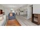 Open-concept living room with mirrored wall, seamlessly connected to the kitchen, promoting an airy feel at 112 W Cypress Ct, Oldsmar, FL 34677