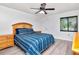 Relaxing main bedroom features a ceiling fan, window with blinds, and light gray wood-look flooring at 112 W Cypress Ct, Oldsmar, FL 34677