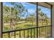 Scenic view from the screened patio, showcasing lush greenery and a glimpse of the tranquil community at 112 W Cypress Ct, Oldsmar, FL 34677