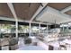 Expansive poolside bar and lounge area with ample seating, modern finishes and views of palm trees at 11500 Myakka Blue Dr, Venice, FL 34293