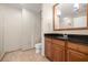 Bright bathroom featuring a wood cabinet vanity, black granite countertop, and tiled floors and shower at 1227 E Madison St # 902, Tampa, FL 33602