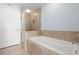 Bathroom featuring a soaking tub with tile surround and a glass-enclosed shower at 1227 E Madison St # 902, Tampa, FL 33602