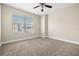 Bright bedroom with carpet flooring, ceiling fan and large window overlooking the city at 1227 E Madison St # 902, Tampa, FL 33602
