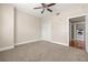 Bedroom featuring carpet flooring, ceiling fan, and a closet, along with an en-suite laundry room at 1227 E Madison St # 902, Tampa, FL 33602