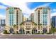 Upscale condo building exterior with attractive architecture, retail space, and manicured landscaping at 1227 E Madison St # 902, Tampa, FL 33602