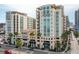 Exterior view of the building complex with palm trees along the street and the building entrance at 1227 E Madison St # 902, Tampa, FL 33602