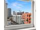 View of the city through a large window, with a clear blue sky in the background at 1227 E Madison St # 902, Tampa, FL 33602
