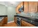 Stylish kitchen with granite counters, stainless steel appliances, and tile backsplash at 1227 E Madison St # 902, Tampa, FL 33602
