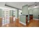 Living area showcasing hardwood floors, an adjacent kitchen area, and plenty of natural light at 1227 E Madison St # 902, Tampa, FL 33602