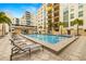 Inviting community pool with lounge chairs and palm trees, perfect for relaxation and enjoying sunny days at 1227 E Madison St # 902, Tampa, FL 33602