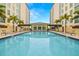 Beautiful swimming pool between two buildings with a clear blue sky overhead at 1227 E Madison St # 902, Tampa, FL 33602