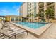 Resort-style pool with lounge chairs and lush landscaping at the property's clubhouse at 1227 E Madison St # 902, Tampa, FL 33602