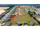 Aerial view of a new development showcasing various homes, green spaces, and a promising community atmosphere at 12407 Hilltop Farms Dr, Dade City, FL 33525