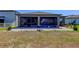 Exterior view showing a large yard, patio, and screened-in porch at 12407 Hilltop Farms Dr, Dade City, FL 33525