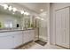 Bathroom featuring double sinks, granite countertop, and a glass-enclosed walk-in shower at 12407 Hilltop Farms Dr, Dade City, FL 33525