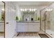 Bathroom with double vanity, granite countertop, and a glass-enclosed shower at 12407 Hilltop Farms Dr, Dade City, FL 33525