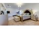 This bedroom features a decorative bed frame, chandelier, treadmill and neutral color palette at 12407 Hilltop Farms Dr, Dade City, FL 33525