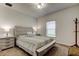 Cozy bedroom with neutral tones, featuring a comfortable bed, stylish nightstands, and soft natural light at 12407 Hilltop Farms Dr, Dade City, FL 33525