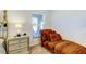 Bedroom chaise lounge next to a window offers relaxation space at 12407 Hilltop Farms Dr, Dade City, FL 33525