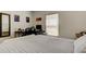 Bedroom featuring a desk, a window with natural light, and neutral decor for relaxation and productivity at 12407 Hilltop Farms Dr, Dade City, FL 33525