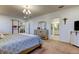 The bedroom includes exercise equipment and a dresser with a mirror in a spacious setting at 12407 Hilltop Farms Dr, Dade City, FL 33525