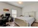 Bright bedroom features a large bed, a desk, and a window for natural light, perfect for work or relaxation at 12407 Hilltop Farms Dr, Dade City, FL 33525