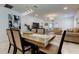 Open-concept dining area with modern lighting, seamless living space, and stylish decor at 12407 Hilltop Farms Dr, Dade City, FL 33525