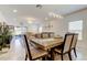 Bright dining space showcasing the table, contemporary lighting, and seamless transition to the living area at 12407 Hilltop Farms Dr, Dade City, FL 33525