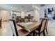 Bright dining room with modern light fixture and a view to the updated kitchen at 12407 Hilltop Farms Dr, Dade City, FL 33525