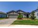 Charming single-story home with a well-manicured lawn and a brick driveway at 12407 Hilltop Farms Dr, Dade City, FL 33525
