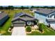Beautiful home featuring solar panels, manicured landscaping, and a welcoming entrance, adding to its curb appeal at 12407 Hilltop Farms Dr, Dade City, FL 33525