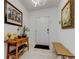 Bright foyer with neutral walls, tile floors, and decorative artwork at 12407 Hilltop Farms Dr, Dade City, FL 33525