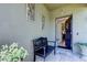 Welcoming front porch with stylish bench and decorative wall art at 12407 Hilltop Farms Dr, Dade City, FL 33525