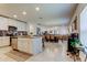 Open-concept kitchen with white cabinets, stainless steel appliances, and island seating at 12407 Hilltop Farms Dr, Dade City, FL 33525
