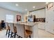 Kitchen island with seating, granite countertops, stainless steel appliances, and stylish decor at 12407 Hilltop Farms Dr, Dade City, FL 33525