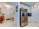 Bright kitchen connecting to the foyer, stainless steel refrigerator, and eat-in area at 12407 Hilltop Farms Dr, Dade City, FL 33525