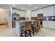 Kitchen with island seating, granite countertops, stainless appliances and views of dining and living areas at 12407 Hilltop Farms Dr, Dade City, FL 33525