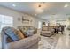 Open concept living room with cozy furniture, neutral tones and access to kitchen area at 12407 Hilltop Farms Dr, Dade City, FL 33525