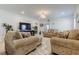 A spacious living room with plush seating, neutral tones, and ample natural light at 12407 Hilltop Farms Dr, Dade City, FL 33525