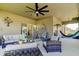 Spacious screened patio with stylish seating, ceiling fan, and decorative plants at 12407 Hilltop Farms Dr, Dade City, FL 33525