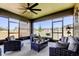 Relaxing screened patio featuring comfortable seating and ceiling fan overlooking the yard at 12407 Hilltop Farms Dr, Dade City, FL 33525