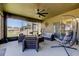 Spacious screened patio with egg chair and wicker furniture, ideal for outdoor relaxation at 12407 Hilltop Farms Dr, Dade City, FL 33525