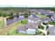 Overhead view of a suburban neighborhood featuring homes surrounding a tranquil pond at 12905 Brookside Moss Dr, Riverview, FL 33579