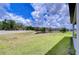Expansive backyard featuring lush green grass and a pond at 12905 Brookside Moss Dr, Riverview, FL 33579