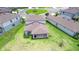 Aerial view of a well-maintained backyard with green lawn, patio, and neighbors at 12905 Brookside Moss Dr, Riverview, FL 33579