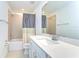Bathroom featuring a shower with a tub, white cabinets, and a large mirror at 12905 Brookside Moss Dr, Riverview, FL 33579