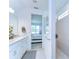 Clean bathroom with a walk-in shower, double sinks, and a view into the bedroom at 12905 Brookside Moss Dr, Riverview, FL 33579